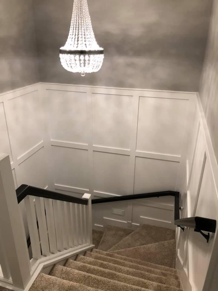 Stairwell with wainscoting, crystal chandelier and Venetian plaster walls