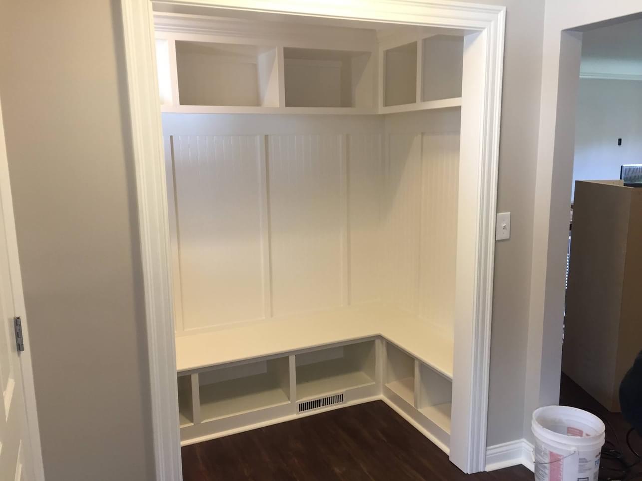 Custom built-in mudroom bench with beadboard panels and cubbies